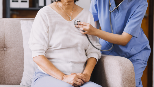 Nurse performing home heart assessment on senior patient