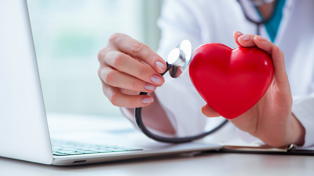 Stethoscope in front of heart-shaped object